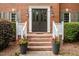Inviting brick front porch with double doors and decorative flowerpots welcomes you to this charming home at 102 Alidade Ct, Cary, NC 27513