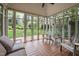 Relaxing gazebo interior with wood floors, comfortable seating, and views of the lush green garden at 102 Alidade Ct, Cary, NC 27513