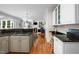 Open kitchen features granite countertops and opens to living room with fireplace at 102 Alidade Ct, Cary, NC 27513