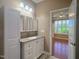 Well-lit bathroom features a vanity with white cabinets, granite countertops, and a decorative mirror at 112 Salmon River Dr, Durham, NC 27705