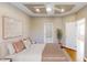 This staged bedroom has a tray ceiling, ceiling fan, and hardwood floors at 112 Salmon River Dr, Durham, NC 27705