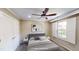 Bedroom boasts a ceiling fan, neutral walls, a large window with shutter blinds, and a comfortable bed at 112 Salmon River Dr, Durham, NC 27705