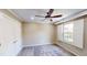 A bright bedroom with a ceiling fan, natural light, fresh paint, and updated flooring at 112 Salmon River Dr, Durham, NC 27705