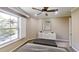Bedroom features a large window with shutter blinds, modern ceiling fan, and neutral paint at 112 Salmon River Dr, Durham, NC 27705