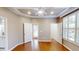 Bedroom featuring hardwood floors, tray ceiling, ceiling fan, and multiple doors at 112 Salmon River Dr, Durham, NC 27705
