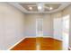 Bright bedroom with hardwood floors, tray ceiling, and ceiling fan at 112 Salmon River Dr, Durham, NC 27705