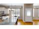 Bright dining area featuring a modern chandelier, large window, and door with plantation shutters at 112 Salmon River Dr, Durham, NC 27705