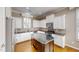 Spacious kitchen with stainless appliances, white cabinetry, and center island at 112 Salmon River Dr, Durham, NC 27705