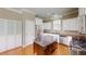 Modern kitchen with white cabinets, stainless steel appliances, and a dark island at 112 Salmon River Dr, Durham, NC 27705
