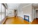 Spacious living room with hardwood floors, a ceiling fan, built-in shelving, and a fireplace at 112 Salmon River Dr, Durham, NC 27705