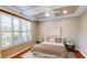 Cozy main bedroom is virtually staged, featuring a tray ceiling, plantation shutters, and stylish decor at 112 Salmon River Dr, Durham, NC 27705
