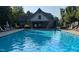 Community pool with lounge chairs and a building in the background at 112 Salmon River Dr, Durham, NC 27705