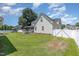 A well-manicured lawn, a screened in porch, and a privacy fence highlight this property's backyard at 114 Boone Trl, Garner, NC 27529