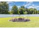 Spacious backyard features a fire pit with seating, ideal for outdoor gatherings at 114 Boone Trl, Garner, NC 27529