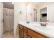Well-lit bathroom includes double vanity with wood cabinets, a mirror, and a separate shower at 114 Boone Trl, Garner, NC 27529