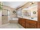 A bright bathroom features double sinks, a soaking tub, and a separate tiled shower at 114 Boone Trl, Garner, NC 27529