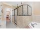 Bright bathroom featuring a tiled shower, a soaking tub, and a tile floor at 114 Boone Trl, Garner, NC 27529