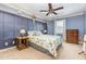 Charming bedroom features paneled accent wall, wood furnishings, and ceiling fan at 114 Boone Trl, Garner, NC 27529