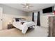 A well-lit bedroom features a bed, a ceiling fan, and neutral colors at 114 Boone Trl, Garner, NC 27529