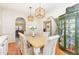 Elegant dining room with hardwood floors, stylish lighting, and a decorative china cabinet at 114 Boone Trl, Garner, NC 27529