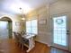 Well-lit dining area with a table, chairs, and natural light from the window, and an exterior door at 114 Boone Trl, Garner, NC 27529