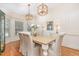 Bright dining room featuring hardwood floors, stylish lighting, and comfortable seating at 114 Boone Trl, Garner, NC 27529