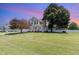 Traditional two-story home with an inviting front porch, well-maintained lawn, and mature shade trees at 114 Boone Trl, Garner, NC 27529
