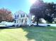 Inviting two-story home boasts a charming front porch, a well-kept lawn, and mature, leafy trees at 114 Boone Trl, Garner, NC 27529