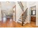 Inviting foyer with hardwood floors, staircase, and a view into the living area at 114 Boone Trl, Garner, NC 27529