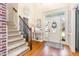 Bright foyer featuring hardwood floors, staircase, and a decorative front door at 114 Boone Trl, Garner, NC 27529