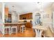 Kitchen with wooden cabinets, granite countertops, stainless steel appliances, island with barstool seating, and an eat-in kitchen at 114 Boone Trl, Garner, NC 27529