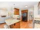 Bright open concept kitchen with wood cabinets, eat-in kitchen island with seating, stainless steel appliances, and granite countertops at 114 Boone Trl, Garner, NC 27529