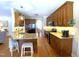 Bright kitchen with stainless steel appliances, wood cabinets, an eat-in kitchen island with barstool seating and granite countertops at 114 Boone Trl, Garner, NC 27529