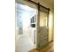 Convenient laundry room with painted barn door, washer, and dryer near bathroom entrance at 114 Boone Trl, Garner, NC 27529
