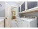 Convenient laundry room with cabinets, washer, and dryer near bathroom entrance at 114 Boone Trl, Garner, NC 27529