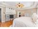 Inviting main bedroom with hardwood floors, ceiling fan, natural light from the windows, and a fireplace at 114 Boone Trl, Garner, NC 27529