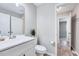 Bathroom featuring white vanity, toilet, and a glimpse into the bedroom beyond at 1221 Teakwood Pl, Raleigh, NC 27606