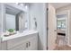 Bathroom showcasing a modern vanity, and a view into a bedroom with wood look floors at 1221 Teakwood Pl, Raleigh, NC 27606