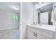 Contemporary bathroom featuring a sleek vanity, modern lighting, and a view to the bedroom at 1221 Teakwood Pl, Raleigh, NC 27606
