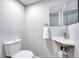 Modern half-bath with a sink, toilet, towel hook and modern fixtures at 1221 Teakwood Pl, Raleigh, NC 27606