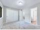 Bedroom with neutral carpet, white walls, closet doors, and an open doorway to the hall at 1221 Teakwood Pl, Raleigh, NC 27606