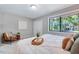 Comfortable bedroom features a tranquil view from the window, as well as a decorative chair and neutral decor at 1221 Teakwood Pl, Raleigh, NC 27606