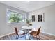 Charming dining area with wood-look floors, updated light fixture, and a large window at 1221 Teakwood Pl, Raleigh, NC 27606