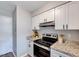 Updated kitchen with stainless steel appliances, granite countertops, and white cabinetry at 1221 Teakwood Pl, Raleigh, NC 27606