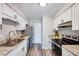 Open kitchen featuring white cabinets, stainless steel appliances, and granite countertops at 1221 Teakwood Pl, Raleigh, NC 27606