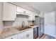 Modern kitchen with stainless steel appliances, white cabinets, and granite countertops at 1221 Teakwood Pl, Raleigh, NC 27606