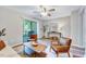 Airy living room featuring neutral walls, an modern ceiling fan and sleek furniture at 1221 Teakwood Pl, Raleigh, NC 27606