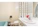 Bathroom with a classic white toilet and vintage sink with a mirror at 1315 Elder Way, Burlington, NC 27215