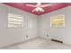 Bright bedroom with white walls, a pink ceiling, and natural light at 1315 Elder Way, Burlington, NC 27215