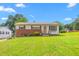 Charming single-story home with a brick facade and a well-maintained lawn and mature trees at 1315 Elder Way, Burlington, NC 27215